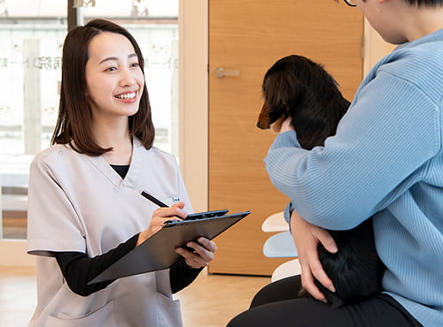 犬を抱く女性